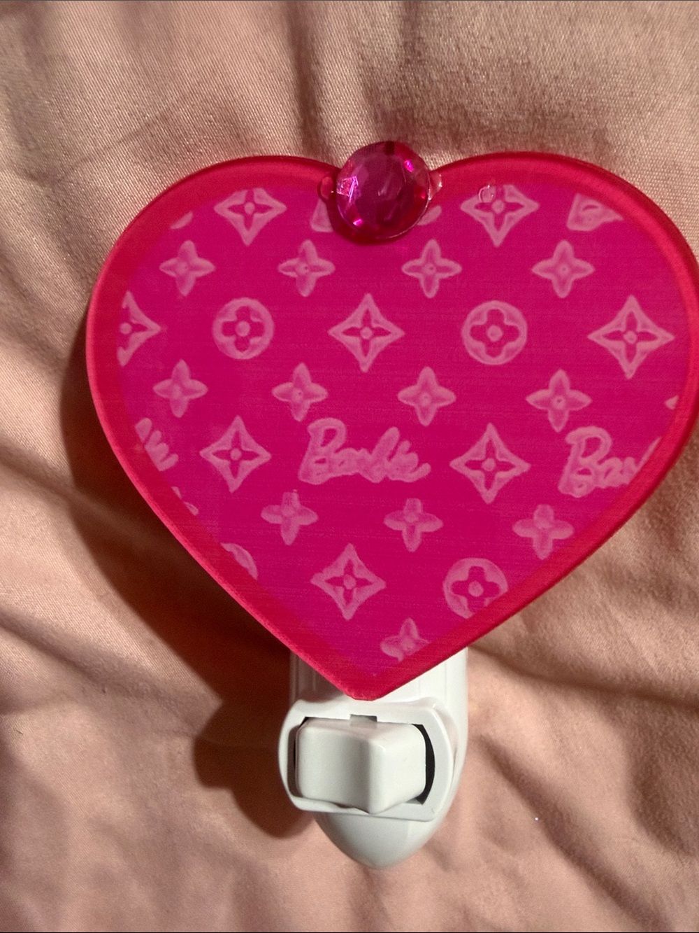 Pink heart plug in night light.  Does not include bulb.